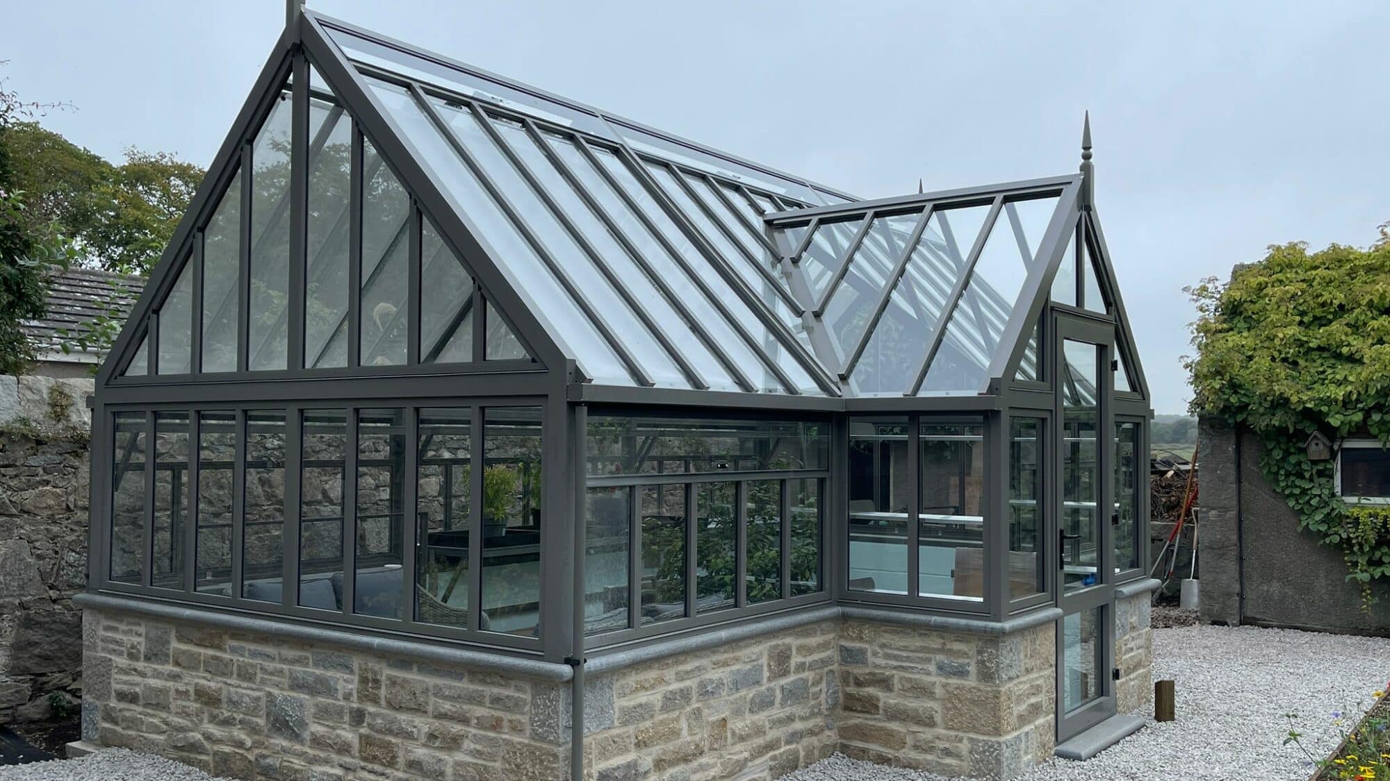 Victorian Porch greenhouse on granite wall Cultivar Greenhouses Inc 