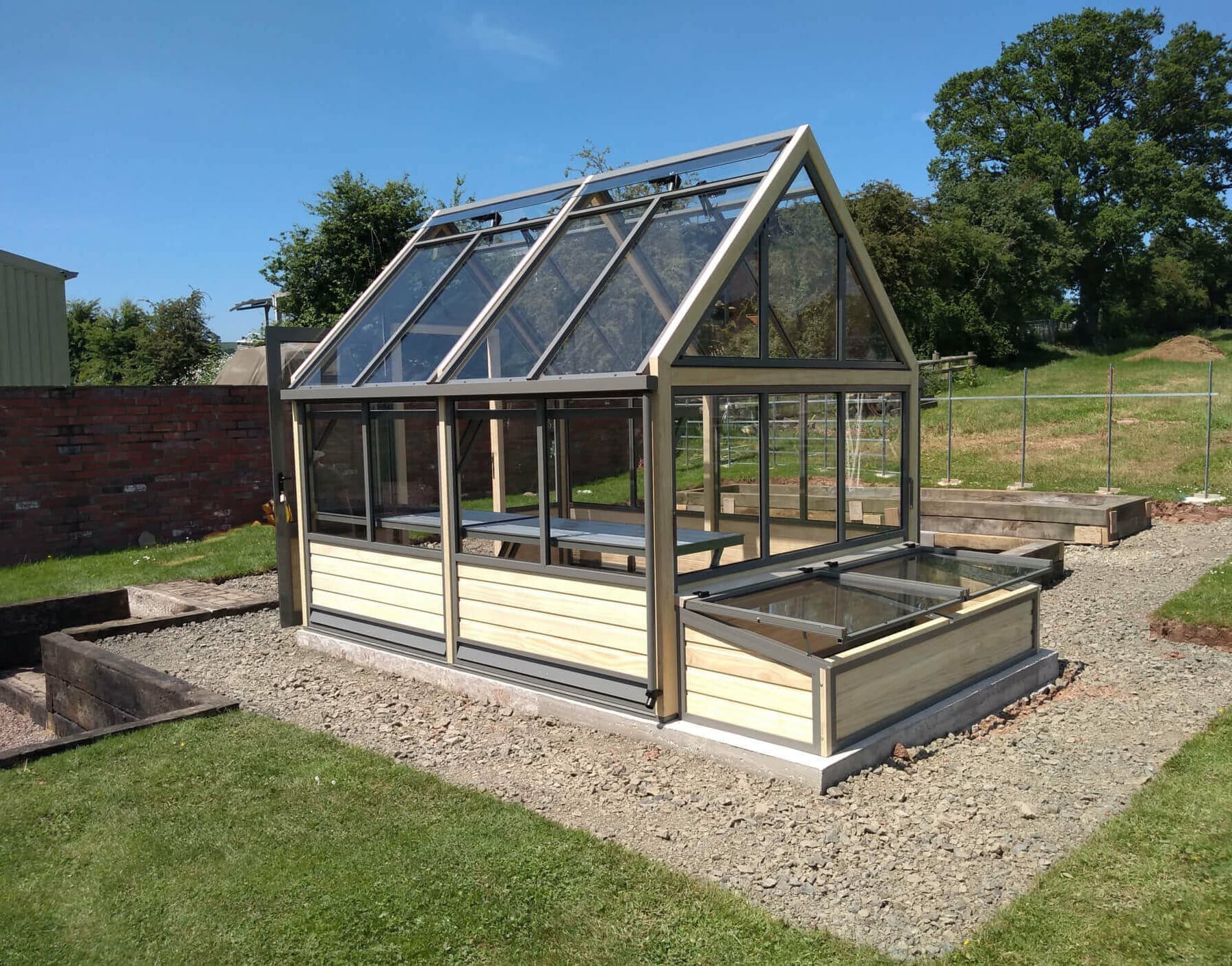 wooden greenhouse and coldframes