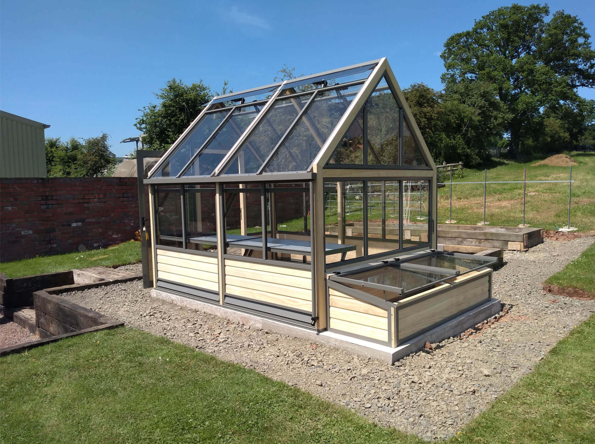 wooden greenhouse and coldframes