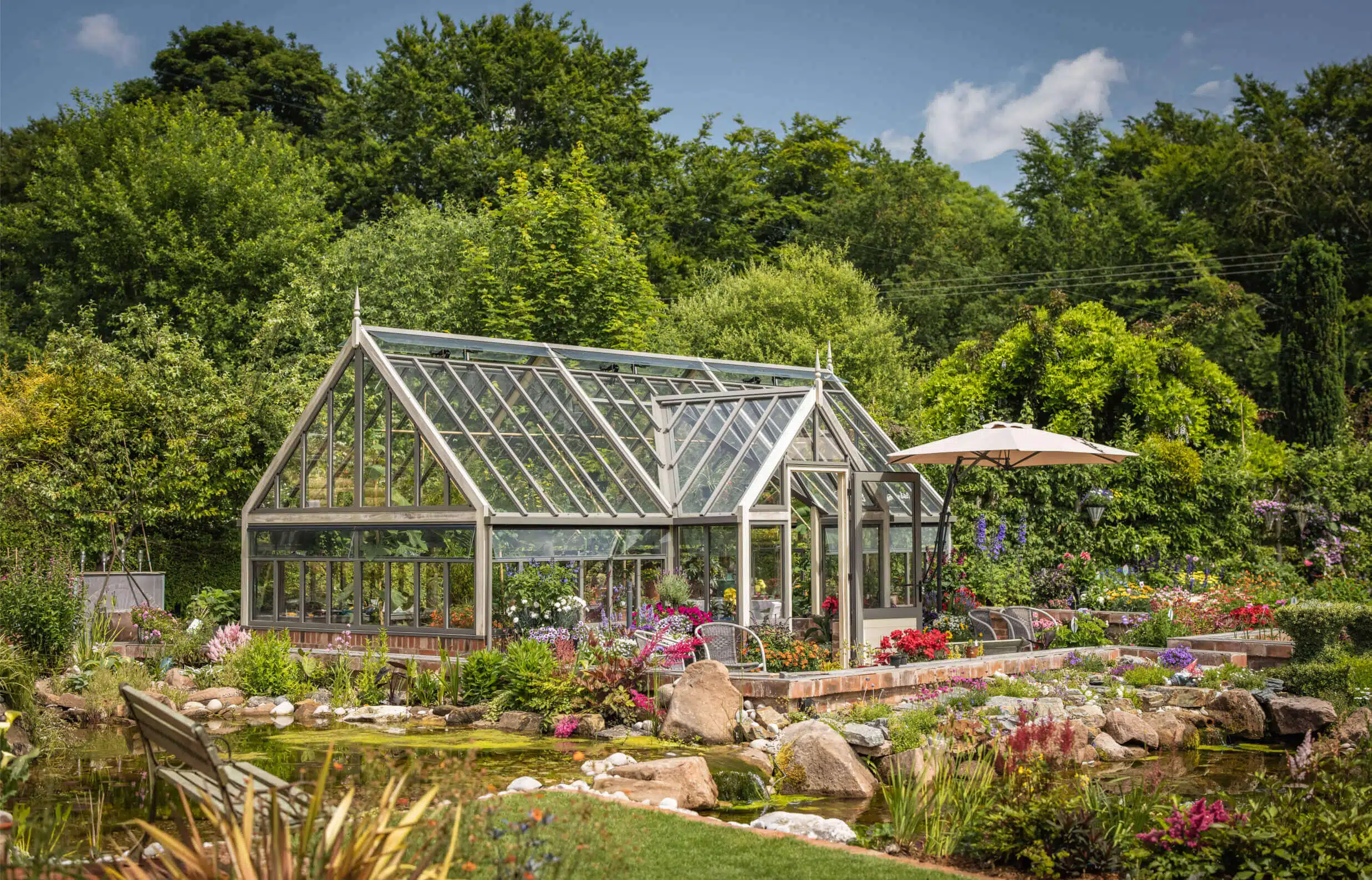 porch greenhouse on dwarf wall surrounded by plants